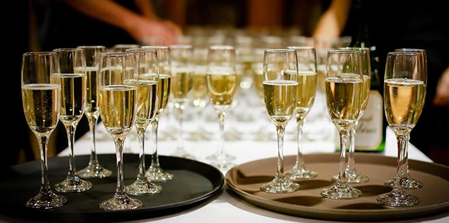 glasses and bottles of champagne pouring