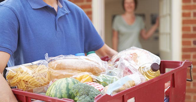 delivery driver carrying groceries ready to be delivered